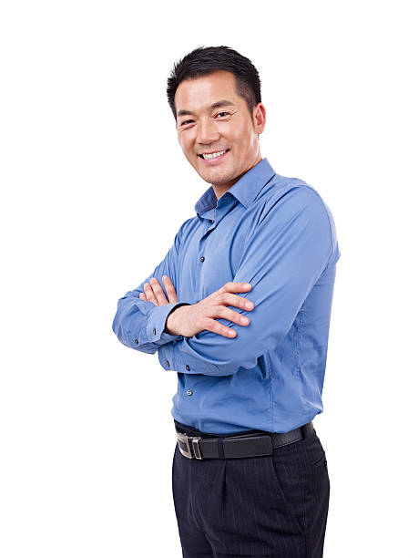 studio portrait of an asian businessman, arms crossed, isolated on white.